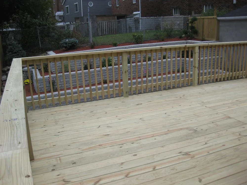 Newly built deck with railing above a Pittsburgh back yard